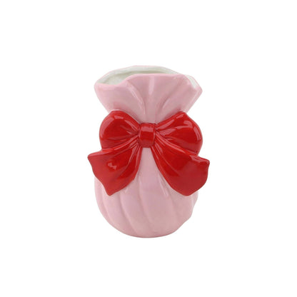 Vaso rosa com laço vermelho em cerâmica.