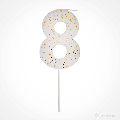 Velas de aniversário branca com mini confetis dourados, com altura 7,6cm. Cada embalagem contém 1 unidade.